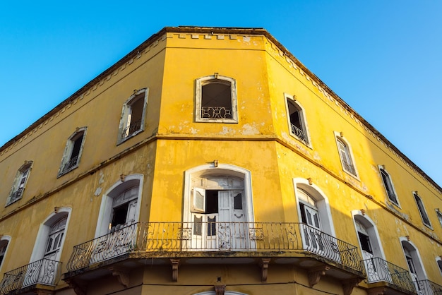 Vista de bajo ángulo de un edificio abandonado amarillo contra un cielo despejado