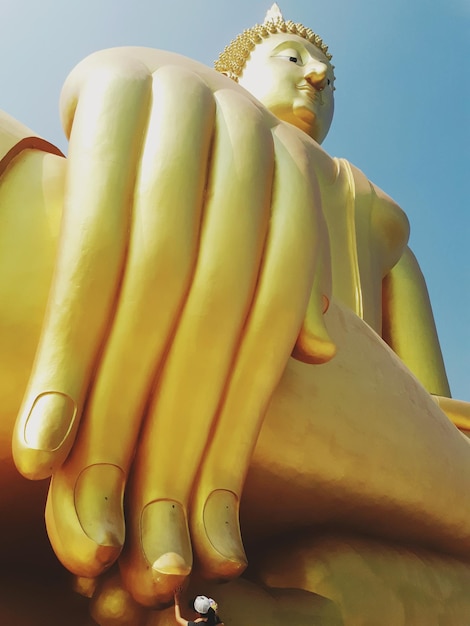 Foto vista de bajo ángulo de la estatua de buda contra un cielo despejado