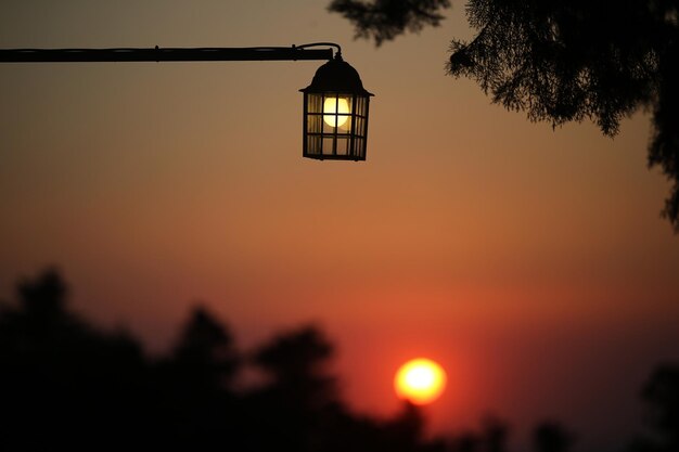 Foto vista de bajo ángulo de la luz de la calle iluminada contra el cielo al atardecer