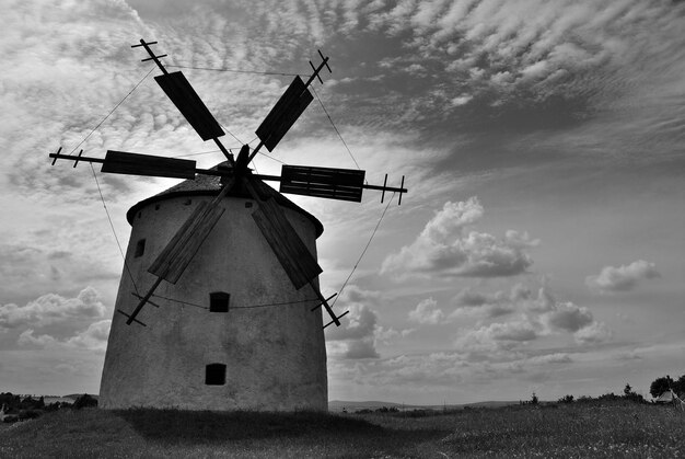 Foto vista de ángulo bajo de molino de viento tradicional en el campo contra el cielo