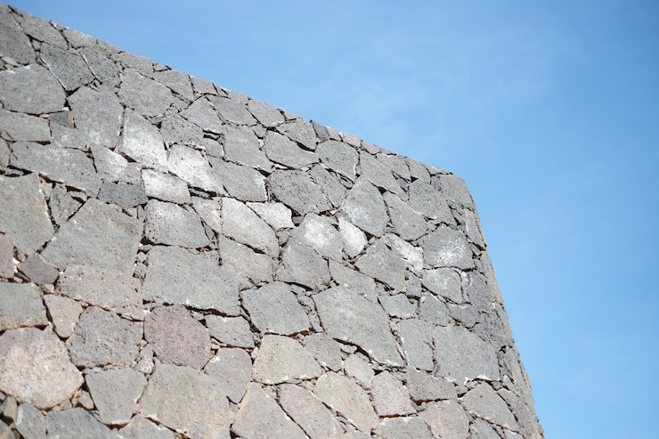 Foto vista en bajo ángulo de la pared de piedra contra el cielo