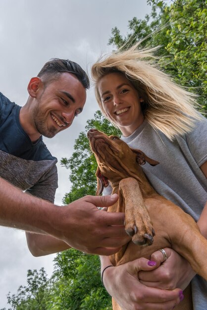 Foto vista desde un ángulo bajo de una pareja con un perro