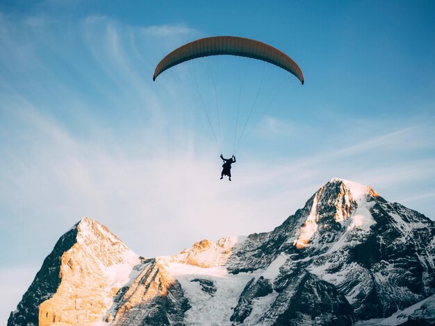 Vista de bajo ángulo de una persona en parapente contra el cielo