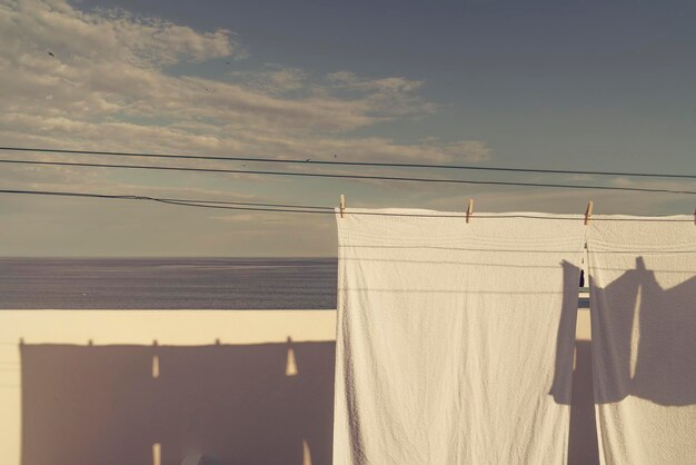 Vista de ángulo bajo de la ropa colgada en la cuerda de la ropa contra el cielo