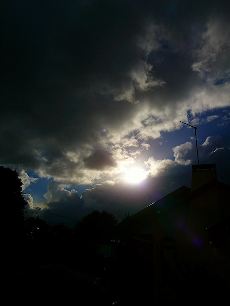 Vista de bajo ángulo del sol brillando a través de las nubes