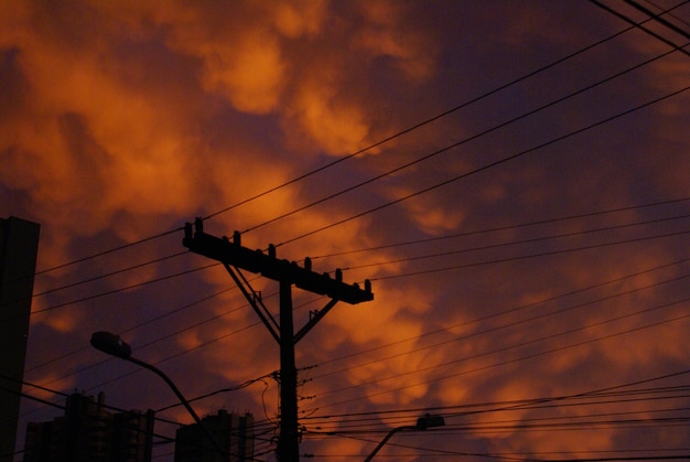 Foto vista de bajo ángulo de la torre de electricidad contra un cielo nublado