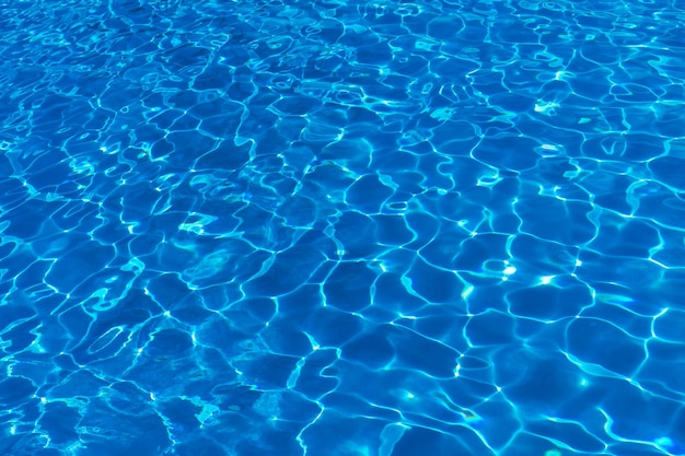 Vista desde arriba de una piscina con ondas y reflejo de la luz del sol