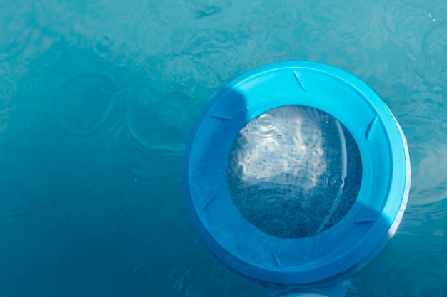 Vista desde arriba del skimmer para limpiar la piscina en agua limpia Primer plano del skimmer montado en una piscina de estructura