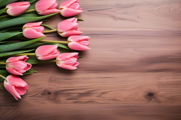 Vista de arriba de los tulipanes rosados en una mesa de madera