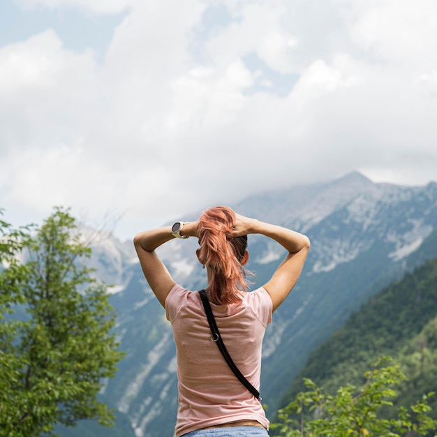 Vista desde atrás de una mujer joven disfrutando de la hermosa naturaleza