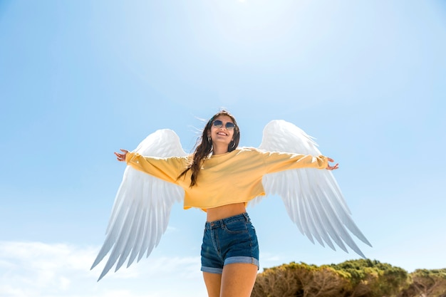 Foto vista baja del ángel con cielo azul