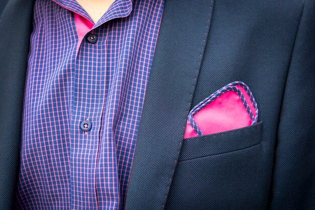 Foto vista de la camisa y el abrigo del joven con un bolsillo un cuadrado de color púrpura rojizo. accesorios para trajes de hombre. traje de invitado de boda masculino. estilo masculino. traje de cena formal para hombres. cuello masculino desabotonado.