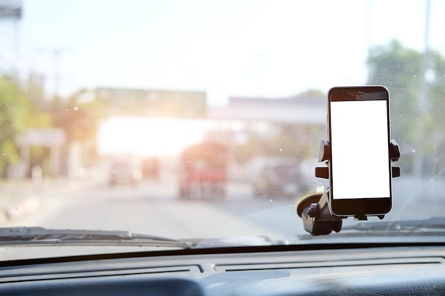 Vista de captura recortada El conductor usa el teléfono mientras conduce Teléfono inteligente moderno con bordes redondeados Pantalla aislada para maqueta Pantalla de navegación del automóvil en segundo plano