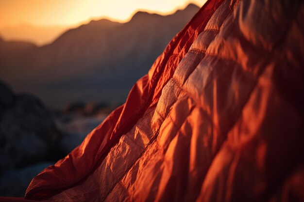 Vista de cerca del saco de dormir naranja en las montañas en el fondo ai generativo