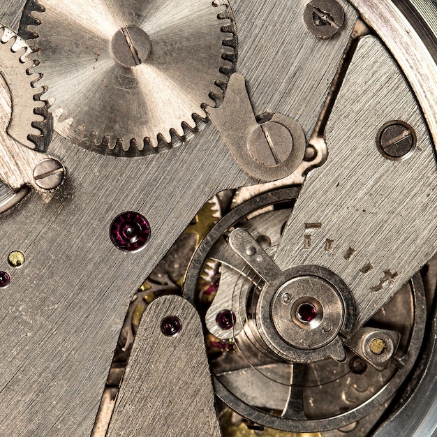 Vista cercana del mecanismo de reloj antiguo con engranajes y engranajes para el diseño de su negocio exitoso Macro