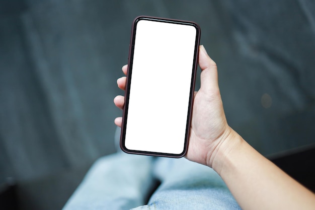 Vista cortada de las manos de las mujeres sosteniendo un teléfono celular copia en blanco pantalla espacial teléfono inteligente con concepto de tecnología