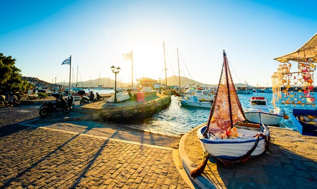 Vista da baía turquesa e iates no cais pedregoso da ilha grega do sol paros