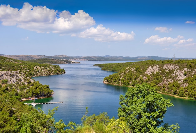 Vista da ponte sibenik para o desfiladeiro do rio krka em direção ao mar adriático. a jusante da cidade de skradin, dalmácia, croácia. imagem romântica do litoral.