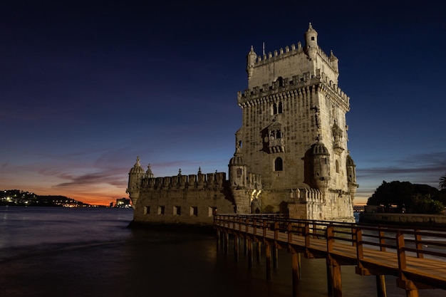 Vista da torre de belem na margem do rio tejo na noite de lisboa