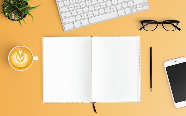 Vista de alto ângulo de laptop e café com livro em fundo laranja