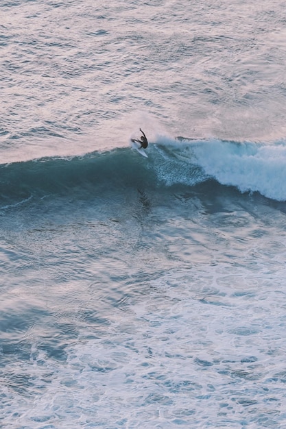 Vista de alto ângulo de um homem surfando no mar