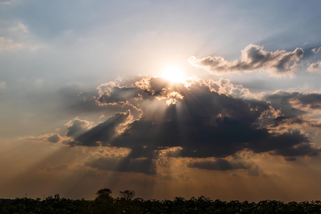 Foto vista de ângulo baixo da luz solar fluindo através das nuvens durante o pôr-do-sol