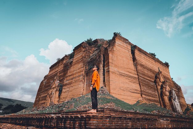 Foto vista de ângulo baixo de um homem de pé no templo contra o céu