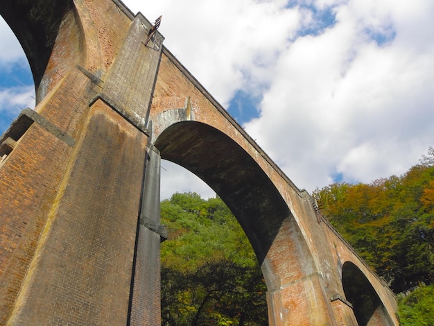 Foto vista de baixo ângulo da ponte de arco contra o céu