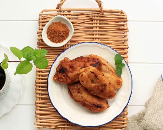 Vista de cima Banana frita (Pisang Goreng ou Kluay Tod), Fritada de banana frita com massa de farinha, servida com açúcar de palma. Popular para tomar café da manhã