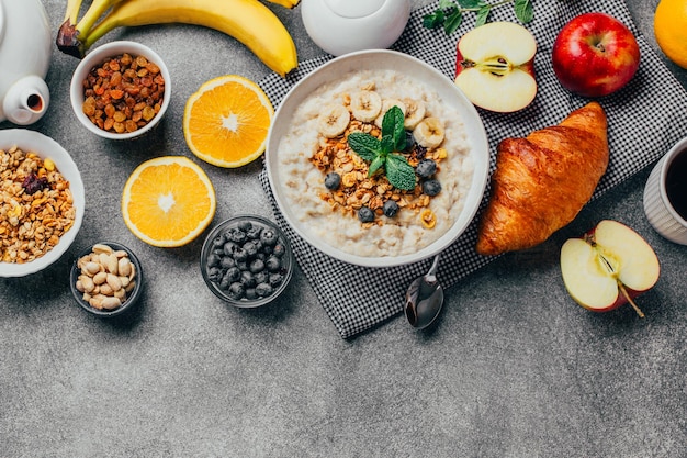 Foto vista de cima de frutas legumes mingau chá frutas secas nozes em uma mesa cinza