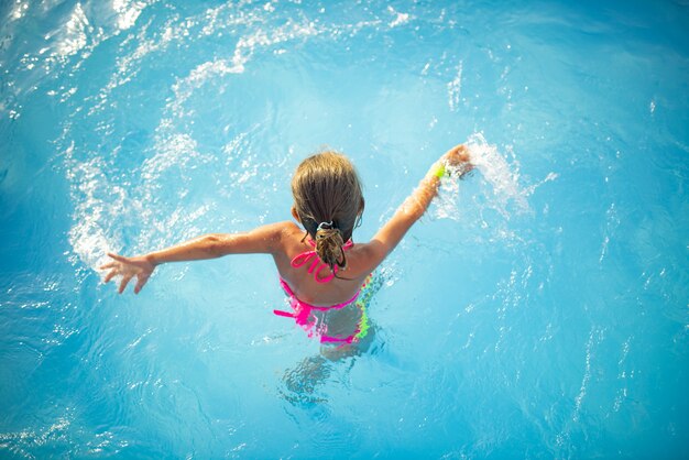 Vista de cima, garota adolescente nadando na piscina