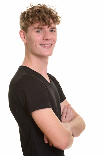 Vista de perfil de um jovem feliz com cabelo loiro encaracolado sorrindo