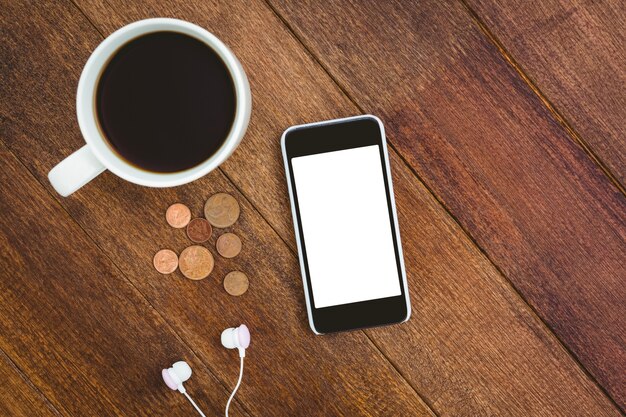 Vista de um smartphone branco com uma xícara de café