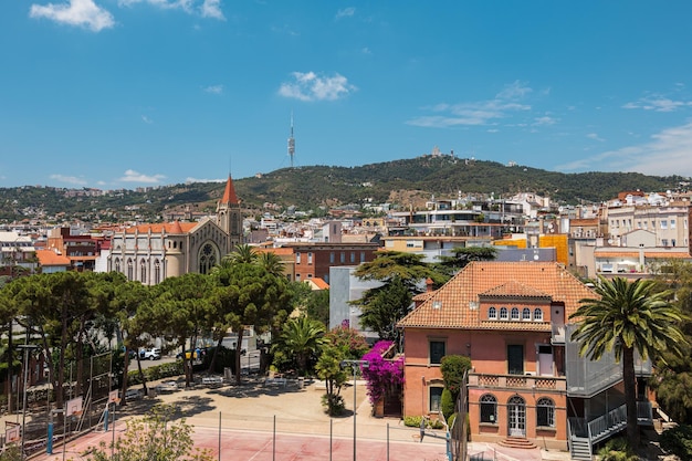 Vista de um telhado de uma típica área de estar em Barcelona com antena e montanha ao fundo