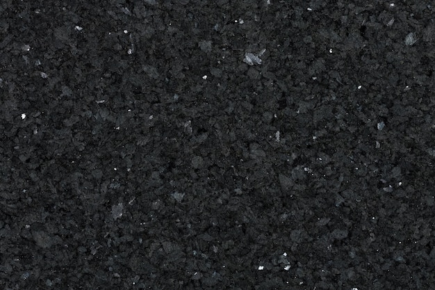 Foto vista detallada de la textura de la superficie de granito negro para su proyecto