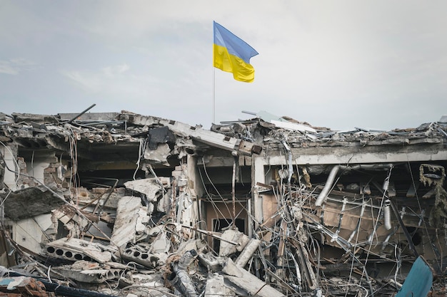 Vista del edificio destruido de las ruinas del edificio y la bandera ucraniana