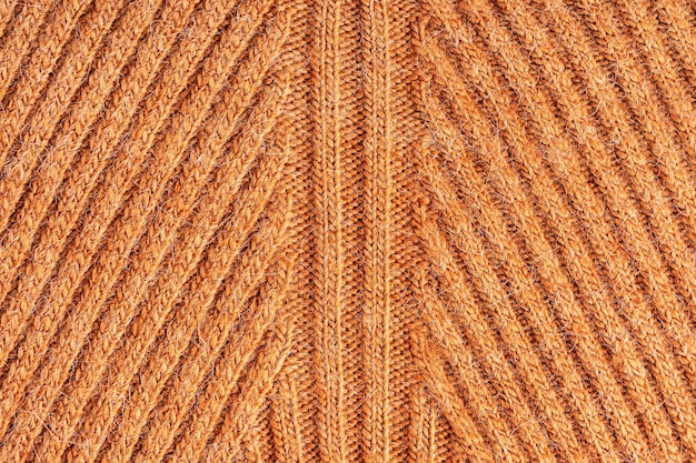 Vista elevada de la textura de un suéter de cardigan tejido cálido, suave y acogedor, tejido con hilo de lana marrón