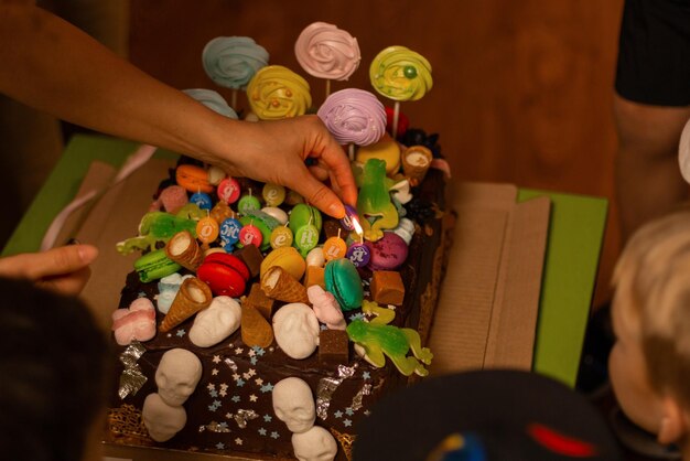 Foto vista em alto ângulo de mãos de pessoas e bolo de aniversário