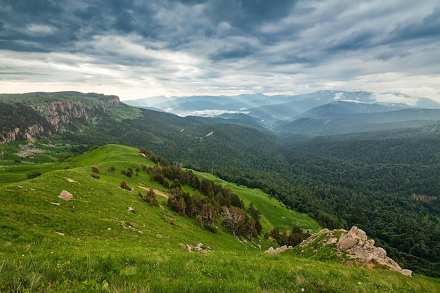 Vista em florestas montanhosas e vale distante ao pôr do sol Lagonaki Cáucaso Rússia