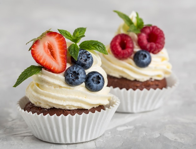 Vista frontal de cupcake saboroso com frutas da floresta
