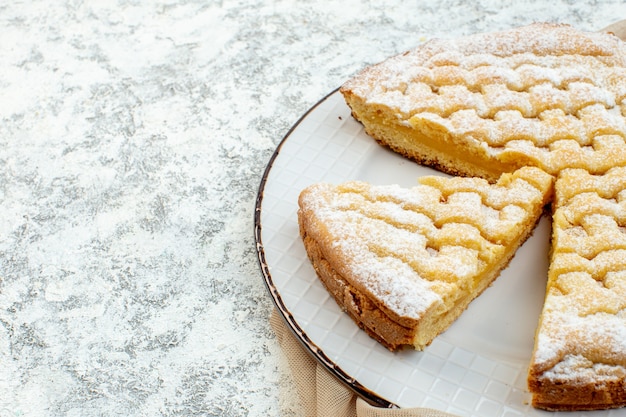 Vista frontal deliciosa tarta de limón azúcar en polvo sobre fondo blanco pastel dulce galleta pastelería té postre hornear azúcar