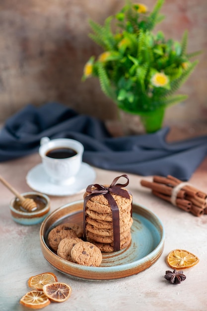 Vista frontal deliciosas galletas dulces atadas con un arco en la superficie de la luz postre dulce pastel de galletas de azúcar masa horizontal