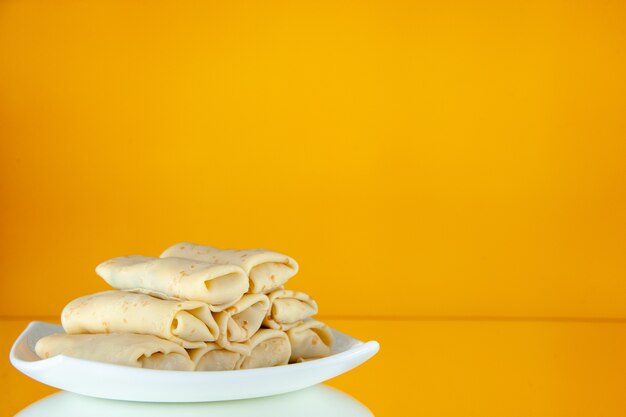vista frontal deliciosas panquecas doces enroladas dentro do prato fundo laranja café da manhã refeição bolo açúcar leite comida manhã cor