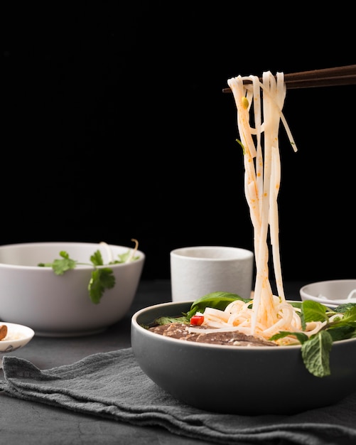 Foto vista frontal de fideos cocidos en un tazón con menta