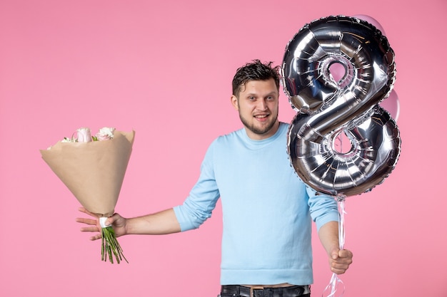 vista frontal jovem do sexo masculino com flores e balões como presente de marcha no fundo rosa casamento sensual amor horizontal feminino dia data igualdade