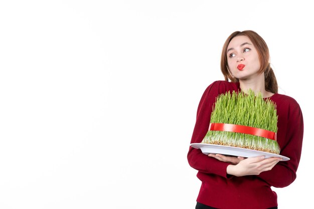 vista frontal jovem fêmea segurando grande novruz semeni no fundo branco etnia família étnica férias conceito primavera artista cores