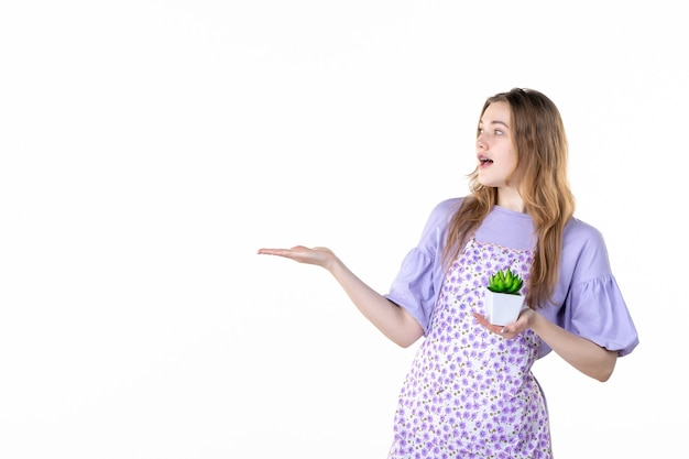 vista frontal joven mujer sosteniendo pequeña planta verde sobre fondo blanco hoja planta trabajo verde jardín de flores hierba planta de interior mujer