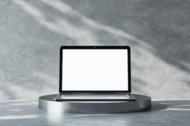 Vista frontal na tela do laptop moderno branco em branco com lugar para o seu logotipo ou texto no suporte redondo metálico escuro no fundo de concreto cinza claro iluminado pelo sol abstrato 3D renderização mock up