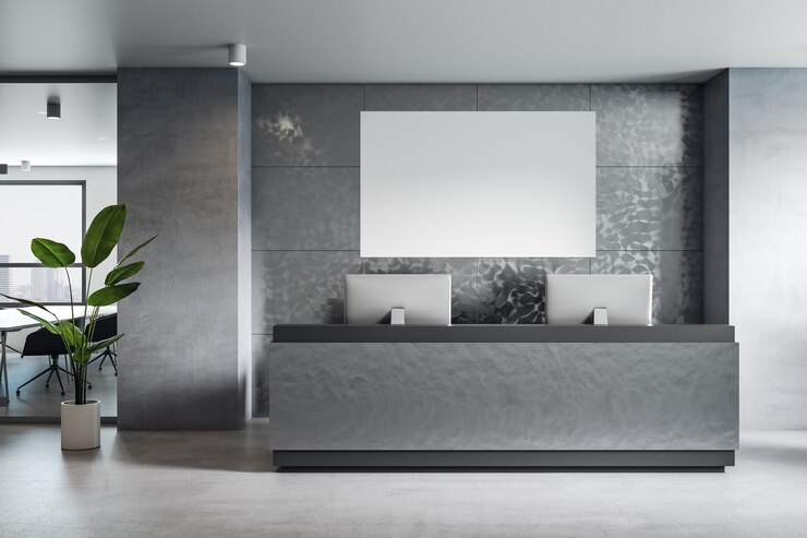 Foto vista frontal no cartaz branco em branco com lugar para o seu logotipo ou texto na parede cinza na área de recepção com piso de concreto de computadores modernos e planta verde renderização em 3d simulado