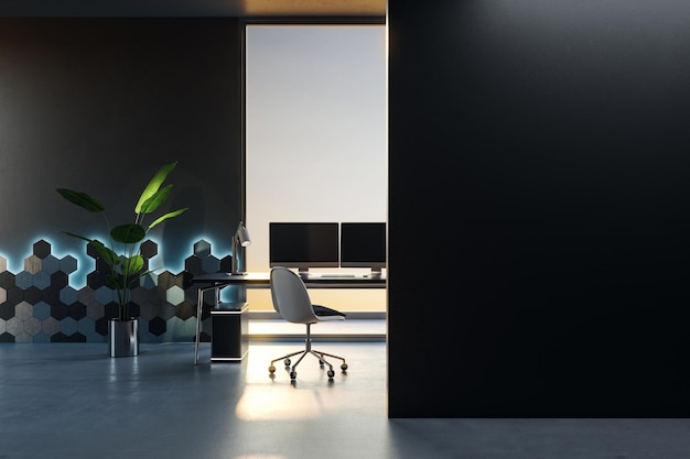 Vista frontal en una pared negra en blanco para afiches o pancartas publicitarias en una sala de oficina interior oscura con computadoras modernas en la mesa del espacio de trabajo y maqueta de renderizado 3D de paredes decoradas con estilo